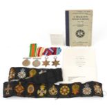 British militaria including four World War II medals and 1943 Seaman's pocket book inscribed F S