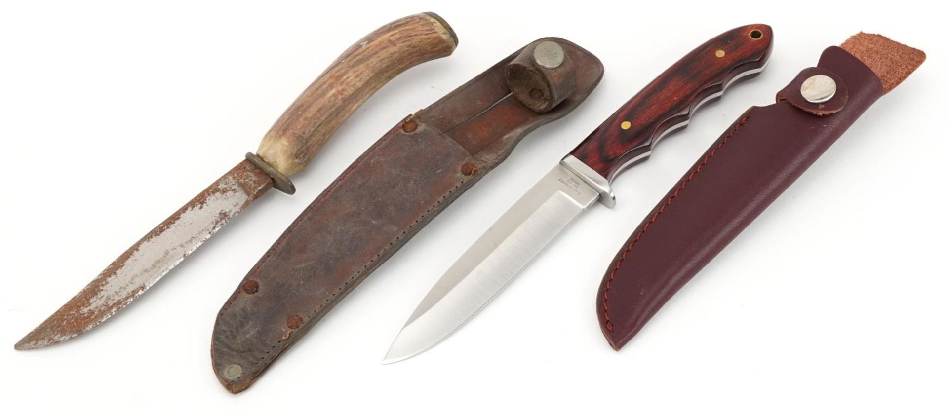 Horn handled hunting knife housed in a leather sheath and a C. Jul Herbertz hunting knife numbered