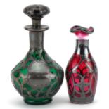 Silver overlaid ruby glass vase and a silver overlaid green glass scent bottle, the largest 11cm