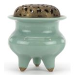 Chinese porcelain tripod censer having a celadon glaze with pierced white metal lid, 10.5cm high :