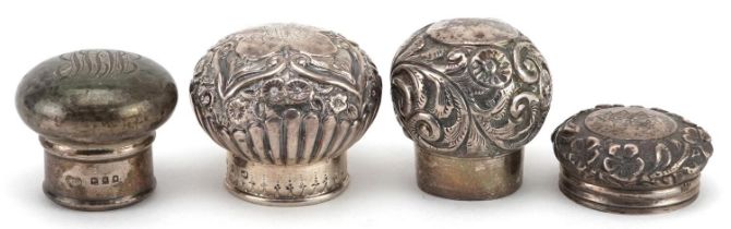 Four silver scent bottle tops including floral examples, various hallmarks including London, the