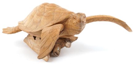 Large carved wood carving of a sea turtle raised on a naturalistic stand, 58cm in length : For