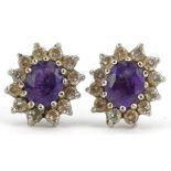 Pair of unmarked gold amethyst and clear stone stud earrings, 9.5mm x 8.2mm, 1.2g : For further