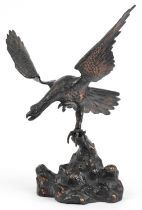 Bronzed cast metal study of an eagle perched on a rock, 44cm high : For further information on