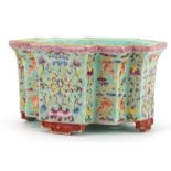 Chinese porcelain four footed planter having a turquoise glaze hand painted in the famille rose