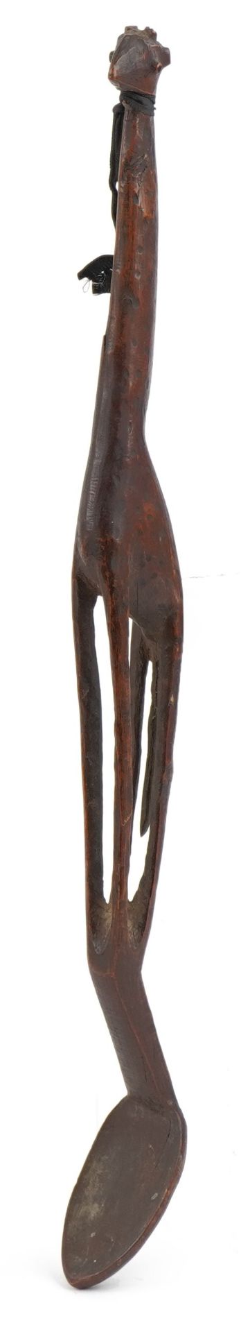 Large tribal interest treen spoon carved with a giraffe, 55cm in length : For further information on