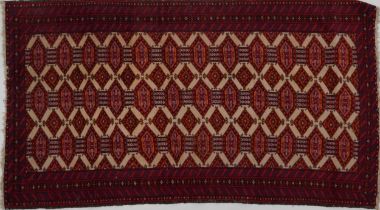 Rectangular Afghan rug having a central field within a red ground border, 165cm x 90cm : For further