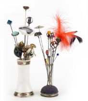 Early 20th century and later hatpins, some silver, together with two hatpin stands, one silver,