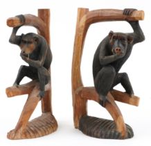 Pair of part stained wood carvings of monkeys on branches, each 30cm high : For further