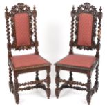 Pair of 19th century oak hall chairs with barley twist supports profusely carved with leaves and