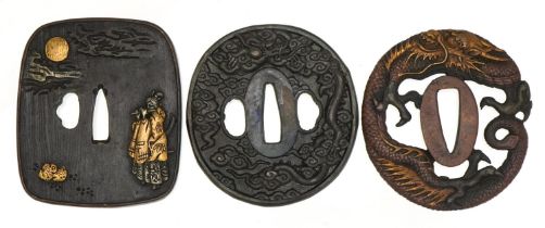 Three Japanese iron tsubas including a mixed metal example cast in low relief with a female