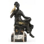 Classical partially gilt patinated bronze figure of a female holding a bird raised on a marble base,