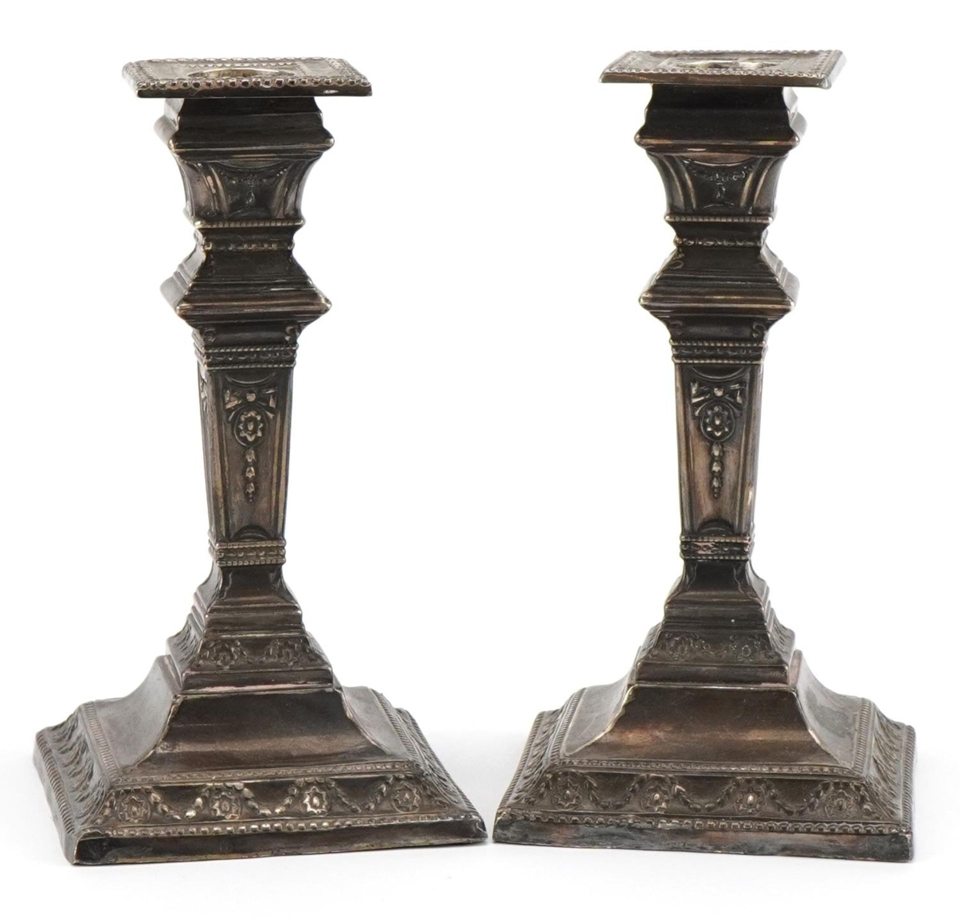 James Deakin & Sons, pair of Victorian silver Adams style square tapering candlesticks embossed with