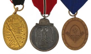 Three German military interest medals including RAD Long Service, Russian Front and Association of