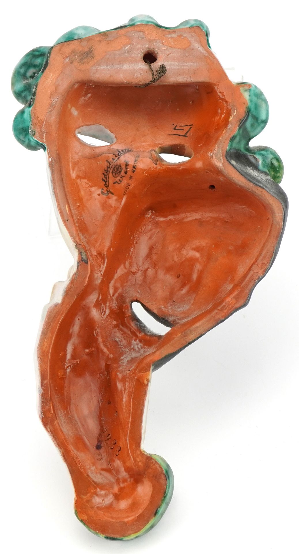 Goldschneider, Austrian Art Deco pottery facemask of a female holding a mask, factory stamp and - Image 2 of 3