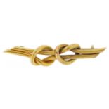 Unmarked gold knot design bar brooch, tests as 9ct gold, 4.5cm wide, 4.2g : For further