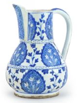 Islamic pottery water jug hand painted with stylised leaves, 21cm high : For further information