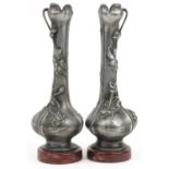Pair of French Art Nouveau cast metal vases decorated with flowers, indistinctly signed, each raised