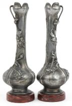 Pair of French Art Nouveau cast metal vases decorated with flowers, indistinctly signed, each raised