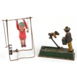 Hand painted cast metal money bank and a clockwork acrobat, 24cm high : For further information on