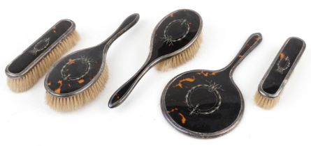 Williams Ltd, George V silver and tortoiseshell five piece dressing table set including hand mirror,