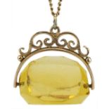 Unmarked gold citrine spinner fob on a 9ct gold necklace, 2.5cm high, 42cm in length, total weight
