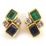 Pair of unmarked gold multi gem stud earrings set with diamonds, emeralds and sapphires, the backs