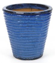 Contemporary ribbed tapering ceramic garden planter having a mottled purple glaze, 42cm high : For