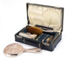 William Neale, George V silver travelling vanity set housed in a velvet and silk lined fitted