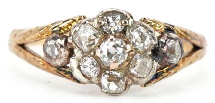 Antique unmarked gold diamond flower head ring with engraved shoulders, each diamond approximately