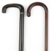 Two hardwood walking sticks including a rosewood example with barley twist section, the largest 91cm