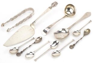 Antique and later silver cutlery including a Thai cake slice, sugar tongs and ladle, the largest