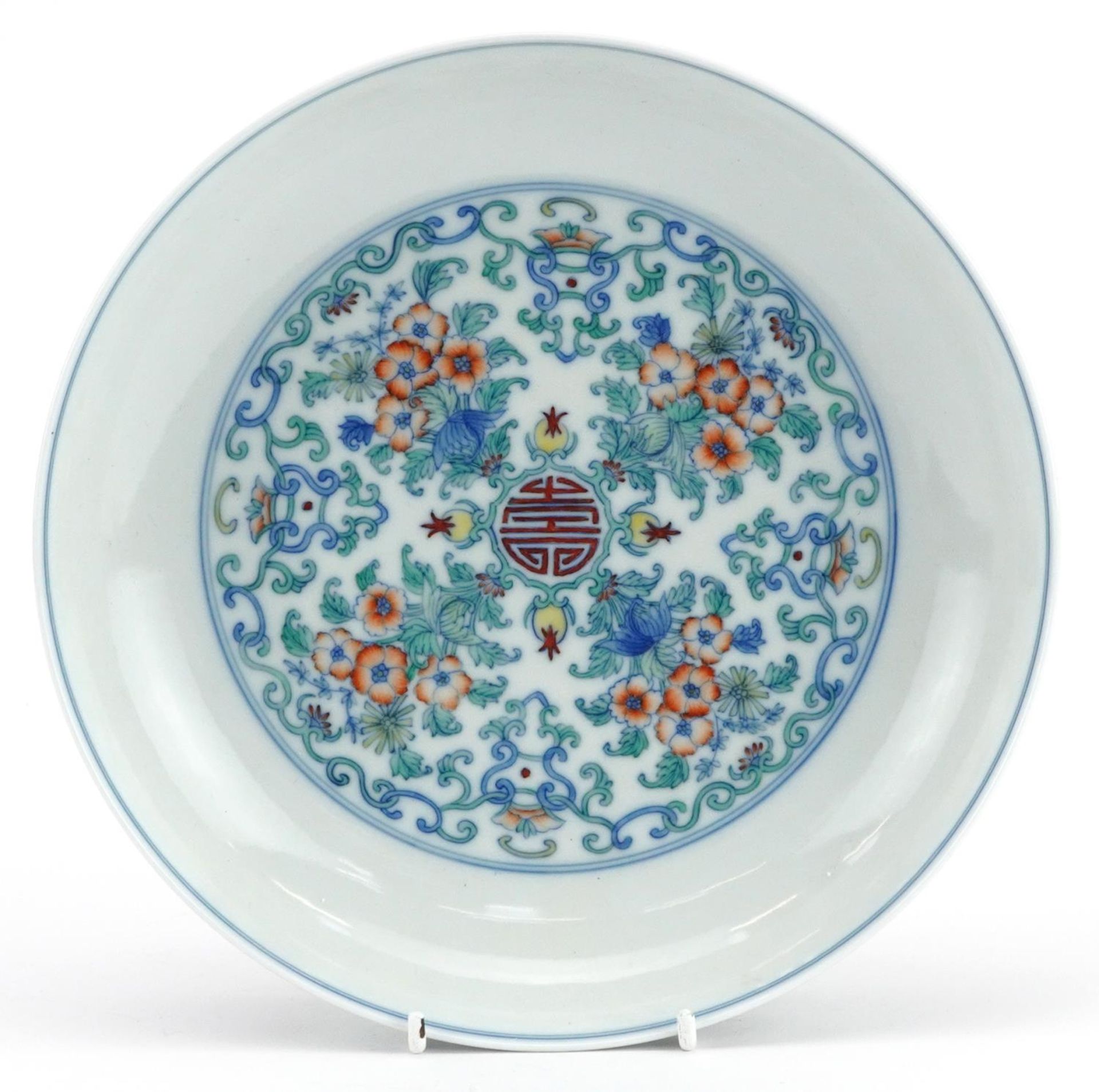 Good Chinese doucai porcelain shallow dish hand painted with flowers amongst scrolling foliage,