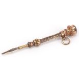 Victorian unmarked gold and yellow metal propelling toothpick with garnet seal end, 5cm in length