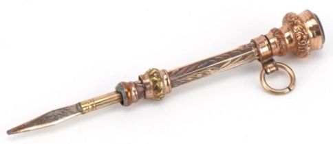 Victorian unmarked gold and yellow metal propelling toothpick with garnet seal end, 5cm in length