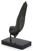 Thai verdigris patinated bronze hand raised on an ebonised stand, overall 22cm high : For further