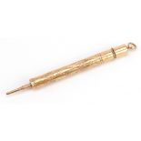 Victorian unmarked gold propelling pencil and dip pen with floral chased case, 7.5cm in length