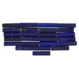 Twenty four pencil cut lapis lazuli, each 20mm x 5mm, approximately 135.07 carat in total : For