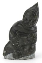 Inuit hardstone carving of an Eskimo, incised marks and paper label to the base, 15cm high : For