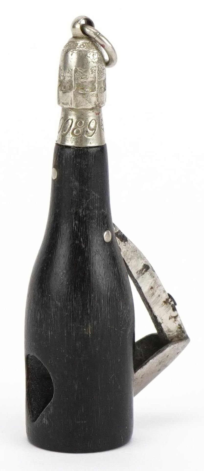 Victorian horn cigar cutter in the form of a Champagne bottle, impressed lozenge mark and numbered