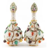 Meissen, large pair of 19th century German floral encrusted bottles with stoppers decorated in