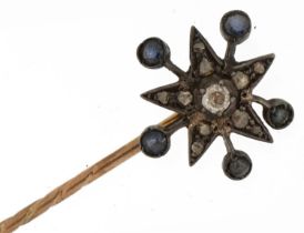 Antique unmarked gold and yellow metal diamond and sapphire starburst stickpin housed in a Grenfell,