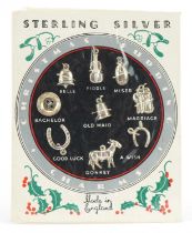 Set of nine sterling silver Christmas pudding charms on original card