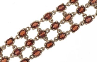 Sterling silver and garnet three row bracelet, 19cm in length, 39.2g