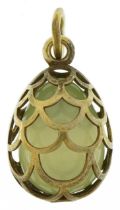 Silver gilt green jade egg pendant, indistinct impressed marks to the suspension loop, 2.8cm high,