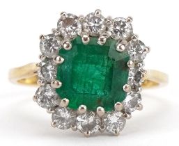 18ct gold emerald and diamond cluster ring, the emerald approximately 8.30mm x 7.70mm x 5.0mm