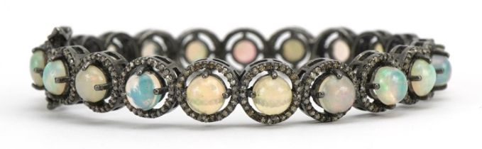 White metal cabochon opal and diamond hinged bracelet, 7.2cm in diameter, 23.7g