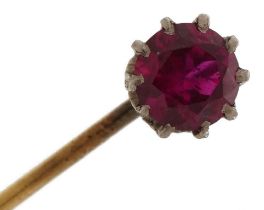 Unmarked gold and yellow metal ruby solitaire stickpin, the ruby approximately 5.80mm in diameter,