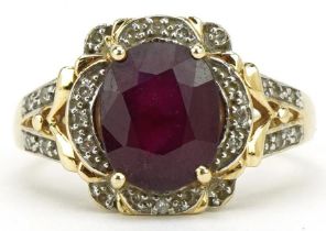 9ct gold ruby and diamond ring with pierced shoulders, the ruby approximately 10.10mm x 8.10mm x 5.