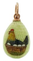 14ct gold green guilloche enamelled egg pendant enamelled with a chicken in a basket with eggs,